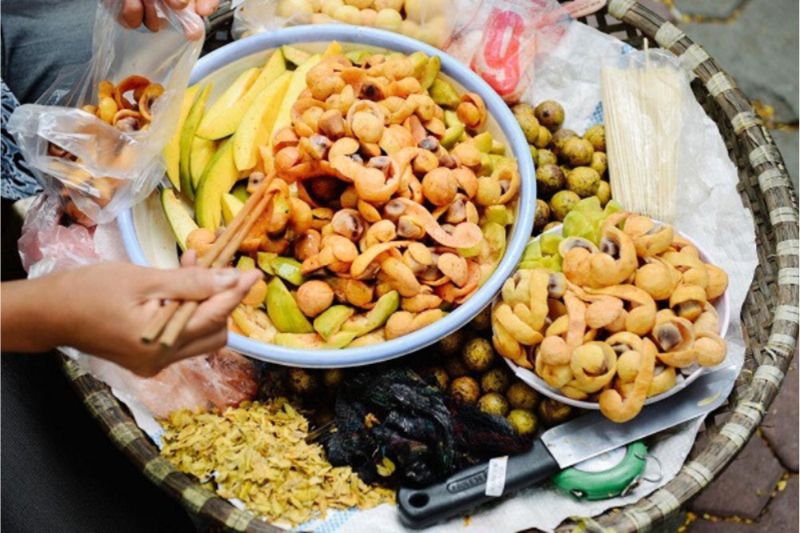 Sour dracontomelon, pickled with chili salt, is a street food in Hanoi